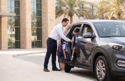 Comfort Drive driver dropping children at a Dubai school in the family car